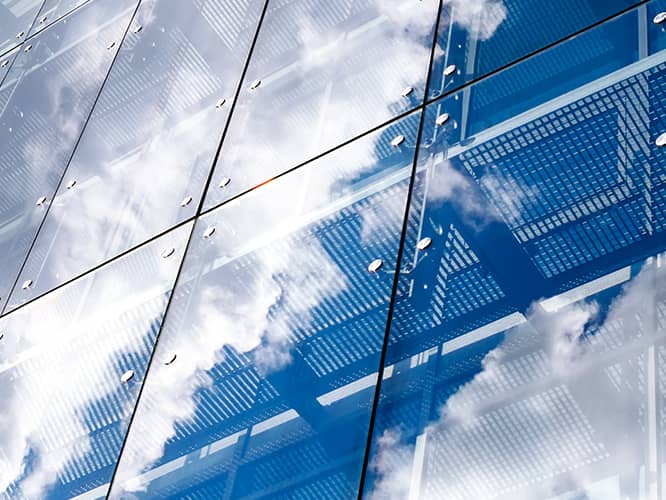 reflection of clouds on a glass building