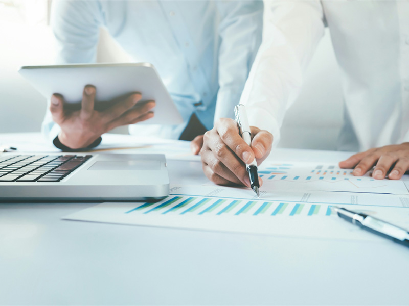 two people with one holding a pen and one holding a tablet