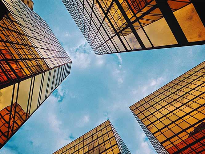upward view of gold glass skyscrapers